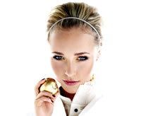 Hayden Panettiere on a white background looking very sexy and seductive with a golden apple. Talk about forbidden fruit.